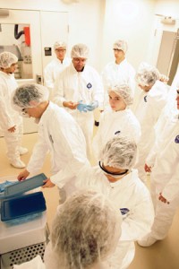 Students don bunny suits to enter the clean room.