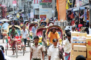 Opposite: Traditional fishing nets, Meghna River in northeastern Bangladesh. Above, top: A typical street in the Sadarghat area of Dhaka, capital of Bangladesh. Above, bottom: River dweller life—marketing, ferrying, hauling by water—on the Buriganga.