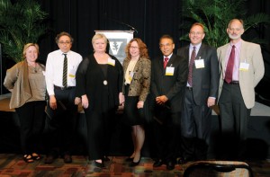 From left, Dean Carolyn Dever congratulates William P. Caferro, Lynn Enterline, Jane G. Landers, William Luis, James Patton and Carl Johnson, who were celebrated at a ceremony in May.