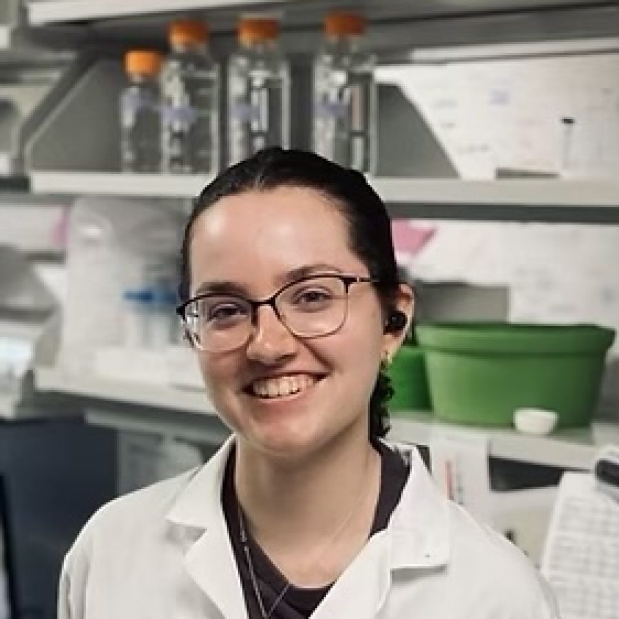 Headshot of white woman with hair pulled back, wearing glasses and white lab coat