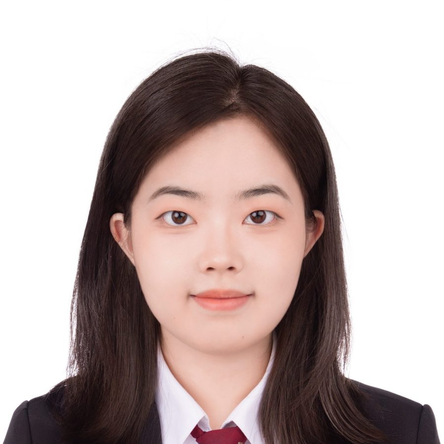 Chinese woman with medium-long hair wearing white shirt, red tie, and dark blazer