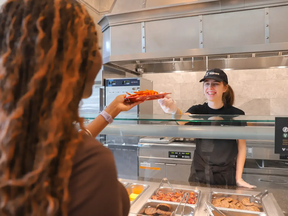 Student being served food at dining hall