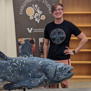 Reese stands with a coelacanth cast