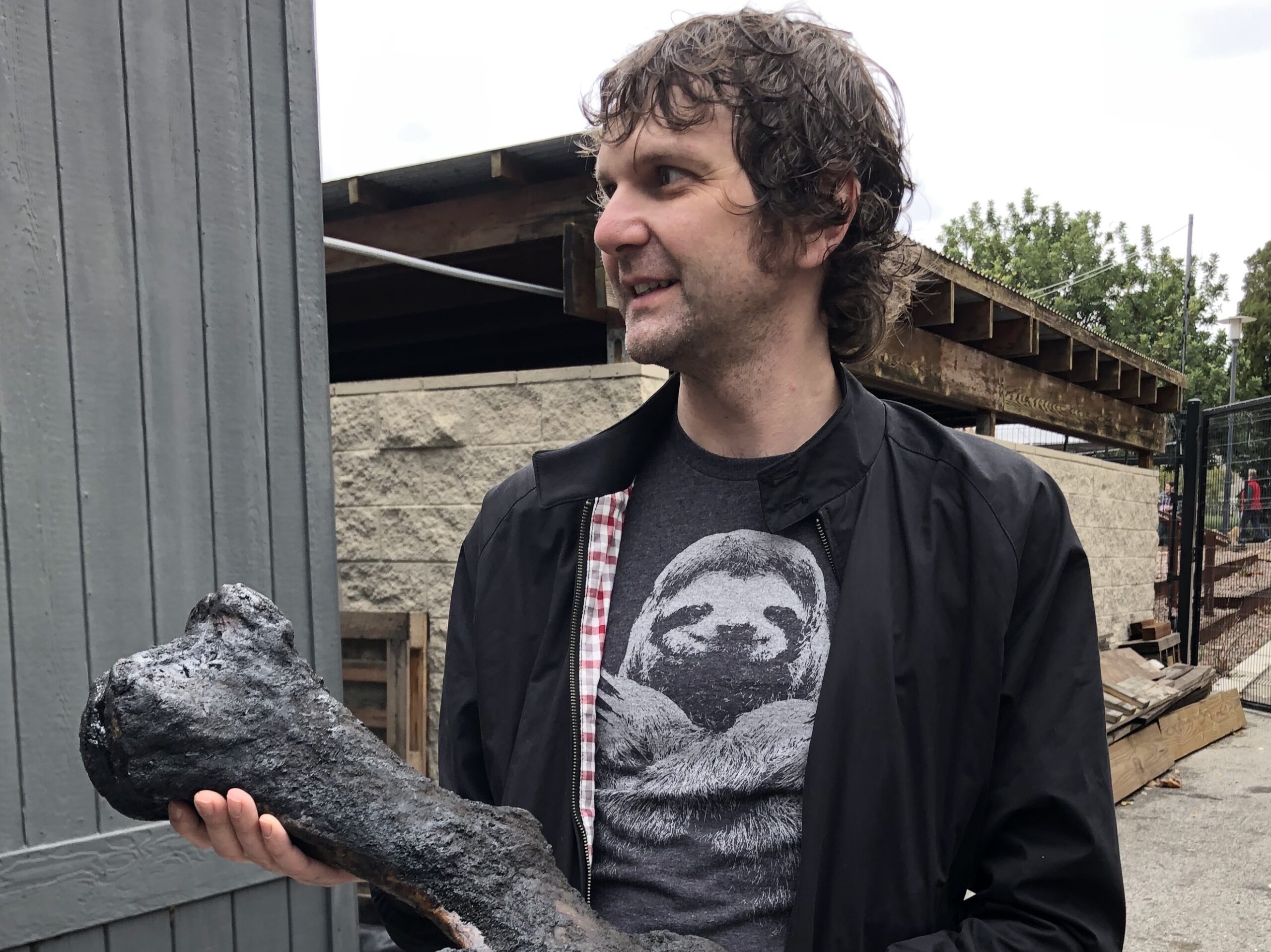 Graham Slater holding a dinosaur bone