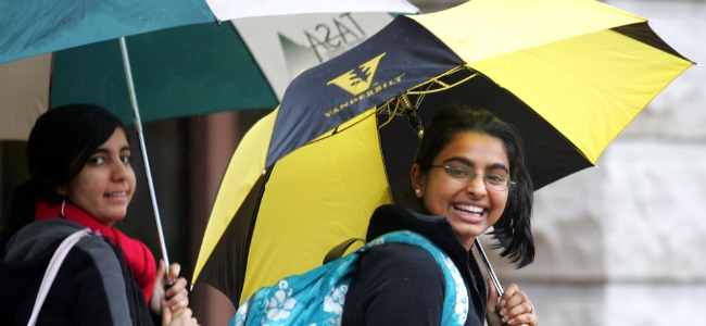 Students walking in the rain outside Wilson Hall