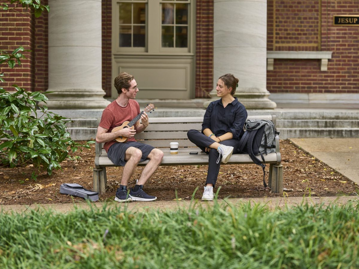 two people talking on a bench