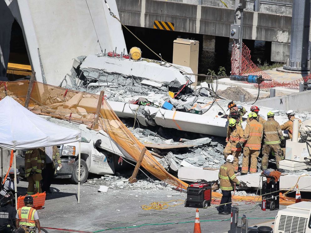 PHOTO: Miami-Dade Fire Rescue Department personnel and other rescue units work at the scene where a pedestrian bridge collapsed at Florida International University on March 15, 2018 in Miami.