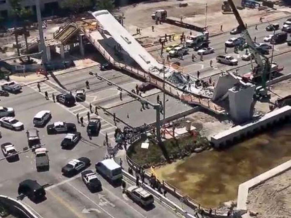 PHOTO: First responders were seen tending to injured victims on the scene of a pedestrian bridge that collapsed on the Florida International University campus. 