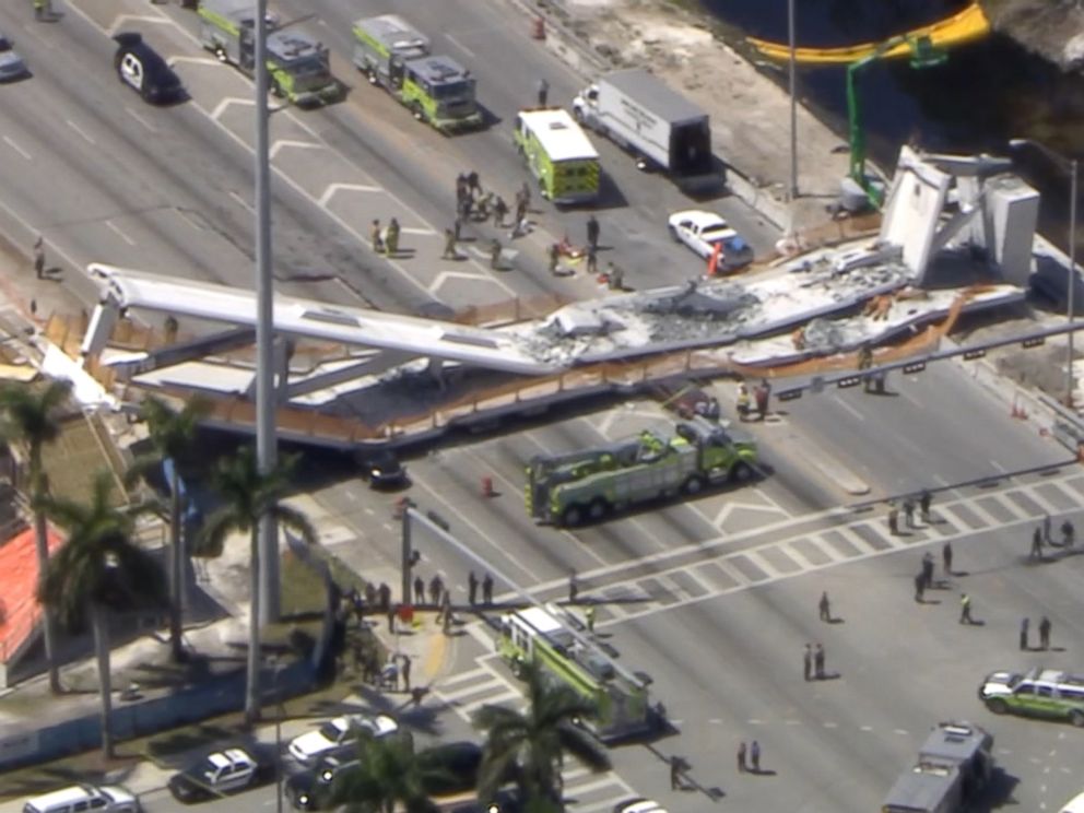 PHOTO: First responders were seen tending to injured victims on the scene of a pedestrian bridge that collapsed on the Florida International University campus. 