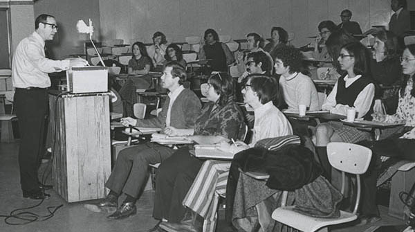 Man teaches a class in a historical photo which appears to be from the 1960s